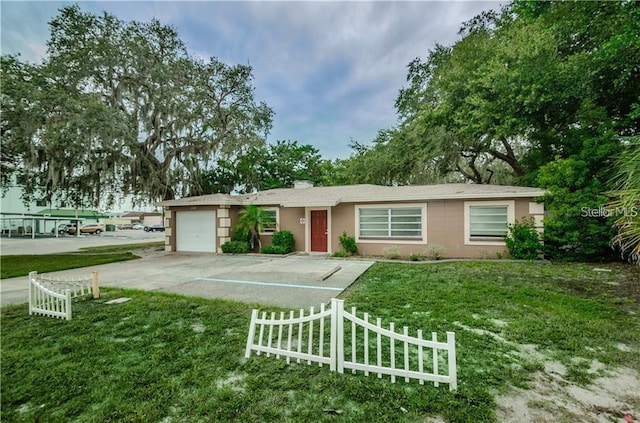6345 Lambert Ln, New Port Richey, FL 34652 - ranch-style home featuring a garage, driveway, and stucco siding