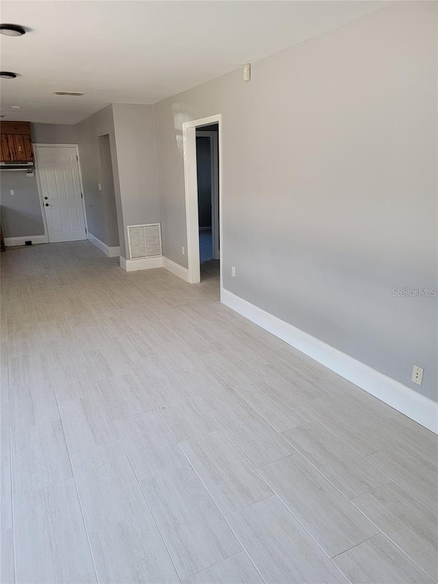 6345 Lambert Ln, New Port Richey, FL 34652 - unfurnished room with baseboards and light wood finished floors