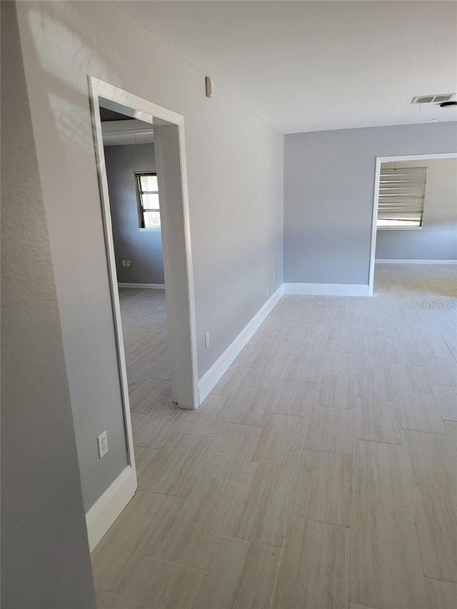 6345 Lambert Ln, New Port Richey, FL 34652 - empty room featuring light wood-type flooring and baseboards