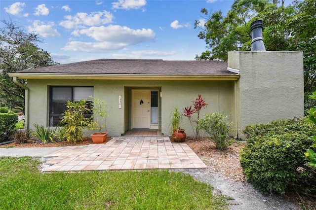 13501 Palmwood Ln Unit 0, Tampa, FL 33618 - view of front of property featuring stucco siding and a patio area