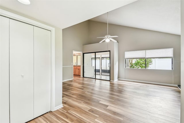 13501 Palmwood Ln Unit 0, Tampa, FL 33618 - unfurnished bedroom featuring baseboards, light wood finished floors, high vaulted ceiling, a closet, and ceiling fan