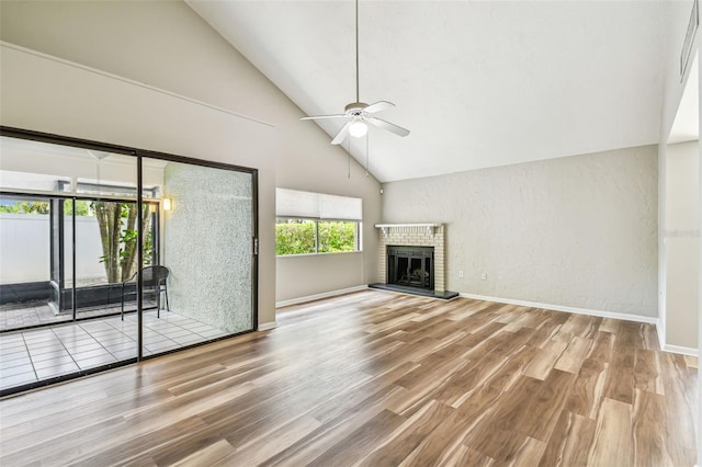 13501 Palmwood Ln Unit 0, Tampa, FL 33618 - unfurnished living room with high vaulted ceiling, ceiling fan, wood finished floors, baseboards, and a fireplace