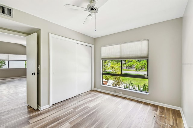 13501 Palmwood Ln Unit 0, Tampa, FL 33618 - unfurnished bedroom featuring wood finished floors, a closet, baseboards, and ceiling fan