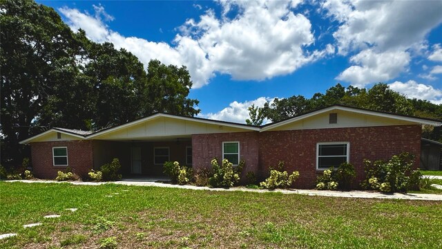 3419 Pearson Rd, Valrico, FL 33596 - ranch-style house featuring brick siding, a front lawn, and an attached carport