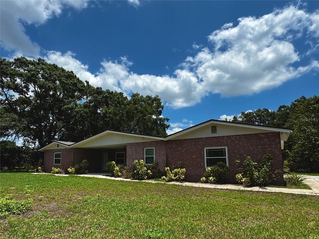 3419 Pearson Rd, Valrico, FL 33596 - single story home with a front yard, brick siding, and a carport