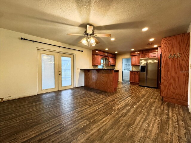 3419 Pearson Rd, Valrico, FL 33596 - kitchen featuring stainless steel refrigerator with ice dispenser, a peninsula, dark wood-type flooring, french doors, and dark countertops