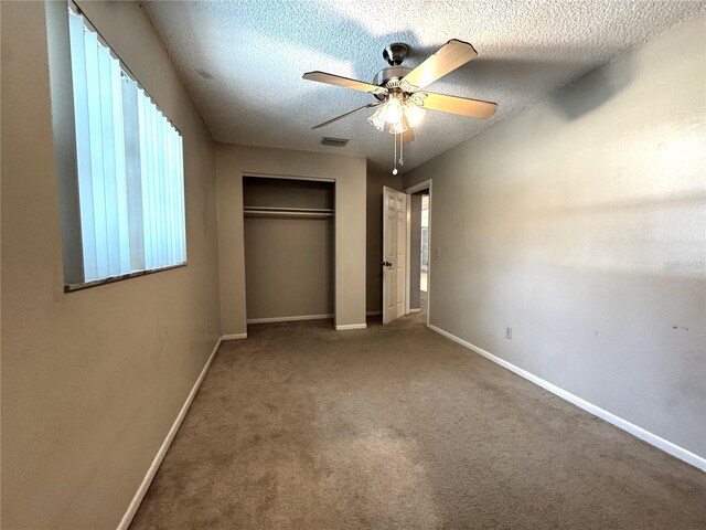3419 Pearson Rd, Valrico, FL 33596 - unfurnished bedroom featuring a closet, baseboards, a textured ceiling, and carpet floors
