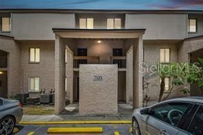 7523 Pitch Pine Cir Unit 184, Tampa, FL 33617 - view of building exterior featuring uncovered parking and cooling unit
