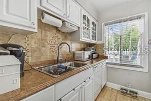 7523 Pitch Pine Cir Unit 184, Tampa, FL 33617 - kitchen with a sink, dishwasher, glass insert cabinets, and white cabinets