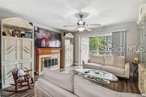 7523 Pitch Pine Cir Unit 184, Tampa, FL 33617 - living area featuring ceiling fan and a glass covered fireplace