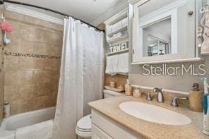 7523 Pitch Pine Cir Unit 184, Tampa, FL 33617 - full bath featuring toilet, vanity, shower / bath combo with shower curtain, and crown molding