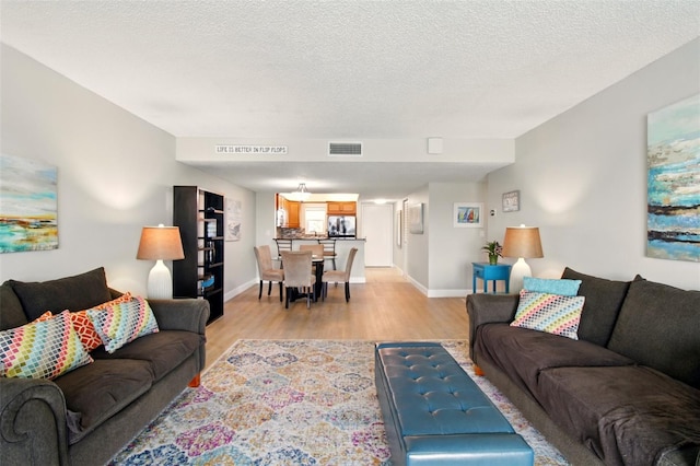 7625 Sun Island Dr S Unit 304, South Pasadena, FL 33707 - living area with light wood finished floors and a textured ceiling
