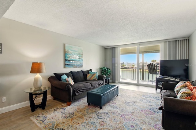 7625 Sun Island Dr S Unit 304, South Pasadena, FL 33707 - living area featuring wood finished floors and a textured ceiling