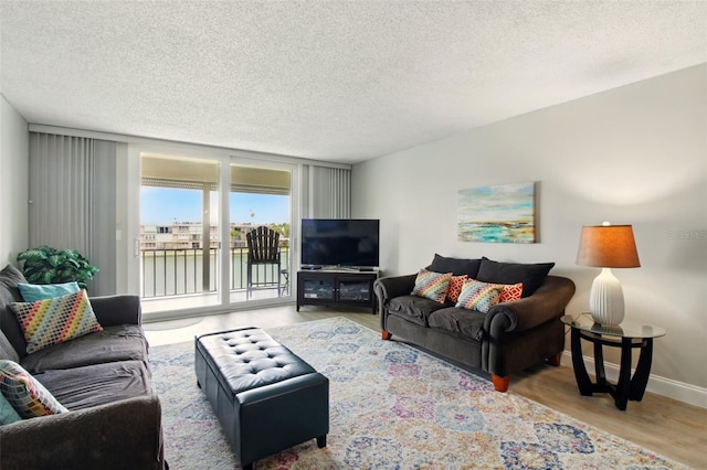 7625 Sun Island Dr S Unit 304, South Pasadena, FL 33707 - living room featuring wood finished floors and a textured ceiling