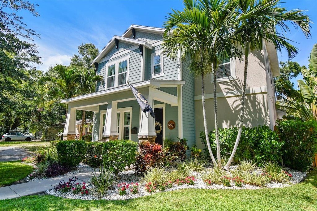 925 Monticello Blvd N, Saint Petersburg, FL 33703 - view of front facade with a porch and a front lawn