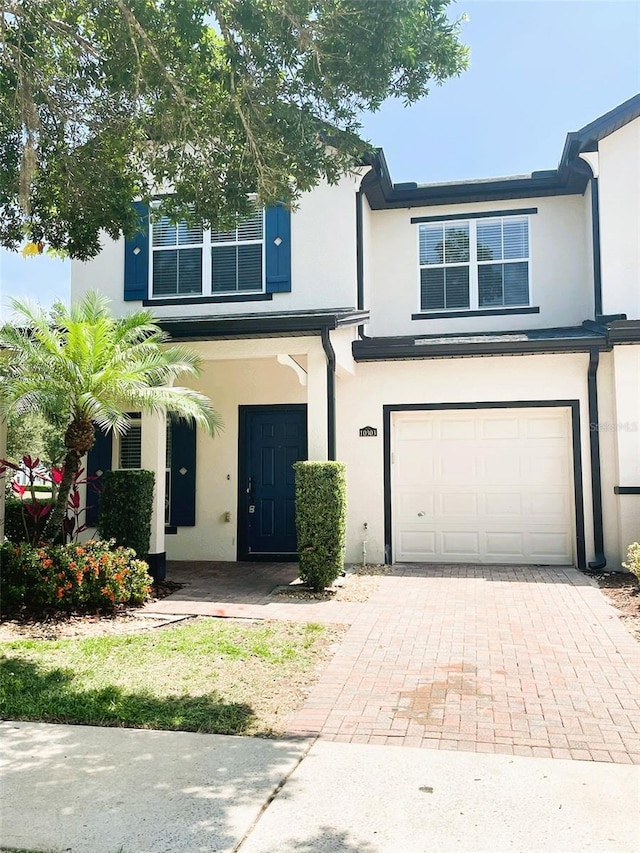 10303 Park Commons Dr, Orlando, FL 32832 - view of front of house with a garage, stucco siding, and driveway
