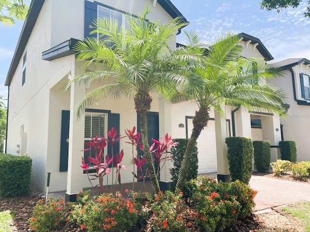 10303 Park Commons Dr, Orlando, FL 32832 - view of front facade featuring a garage and stucco siding