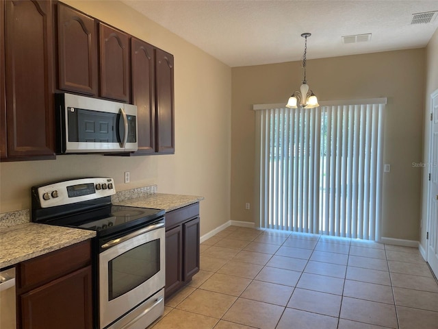 10303 Park Commons Dr, Orlando, FL 32832 - kitchen featuring stainless steel appliances, a chandelier, light countertops, baseboards, and light tile patterned flooring
