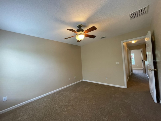 10303 Park Commons Dr, Orlando, FL 32832 - unfurnished room featuring a ceiling fan, baseboards, dark colored carpet, and a textured ceiling