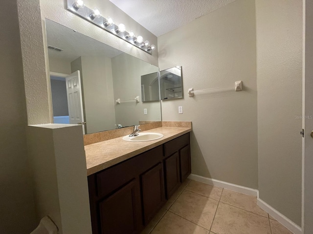 10303 Park Commons Dr, Orlando, FL 32832 - bathroom featuring vanity, tile patterned flooring, a textured ceiling, and baseboards