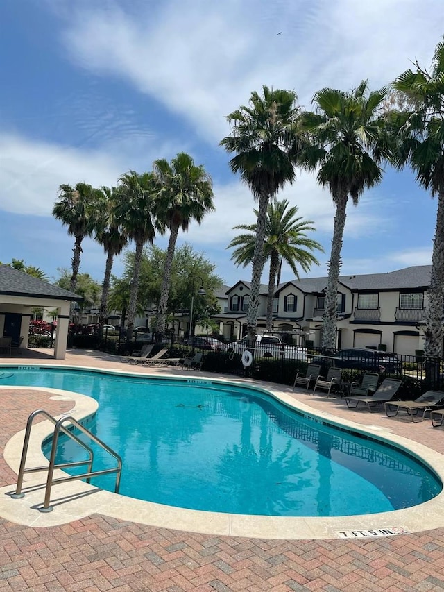 10303 Park Commons Dr, Orlando, FL 32832 - community pool with a patio and a residential view