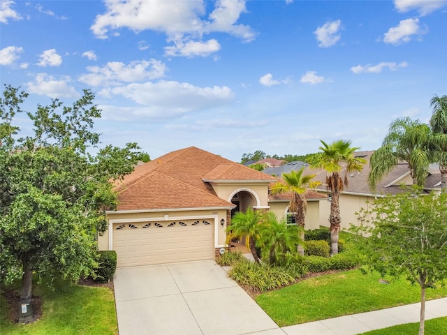 3302 Granite Ridge Loop, Land O Lakes, FL 34638 - view of front of home featuring stucco siding, a garage, concrete driveway, and a front yard