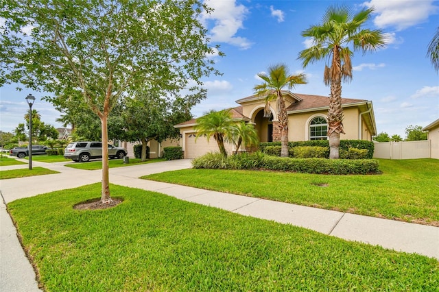 3302 Granite Ridge Loop, Land O Lakes, FL 34638 - mediterranean / spanish house with driveway, stucco siding, and a garage