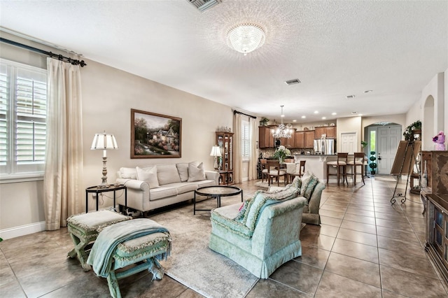 3302 Granite Ridge Loop, Land O Lakes, FL 34638 - living room with light tile patterned floors, baseboards, a chandelier, arched walkways, and recessed lighting