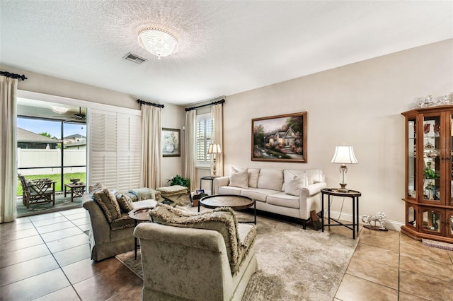 3302 Granite Ridge Loop, Land O Lakes, FL 34638 - tiled living room with a textured ceiling