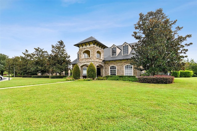 3302 Granite Ridge Loop, Land O Lakes, FL 34638 - view of front facade featuring stone siding and a front lawn
