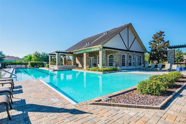 3302 Granite Ridge Loop, Land O Lakes, FL 34638 - community pool featuring a patio, an outdoor structure, and a storage structure