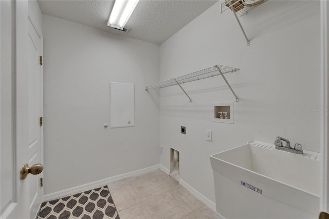 2803 Abbey Grove Dr, Valrico, FL 33594 - laundry room with a textured ceiling, electric dryer hookup, washer hookup, baseboards, and light tile patterned floors