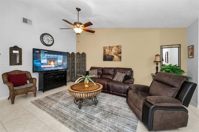 1948 Elaine Dr, Clearwater, FL 33760 - living area featuring light tile patterned floors, ceiling fan, lofted ceiling, a textured ceiling, and baseboards