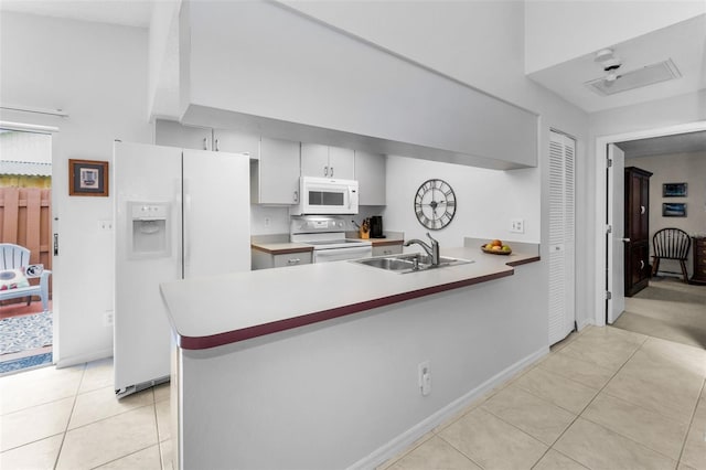 1948 Elaine Dr, Clearwater, FL 33760 - kitchen with white appliances, light tile patterned floors, a sink, a peninsula, and baseboards