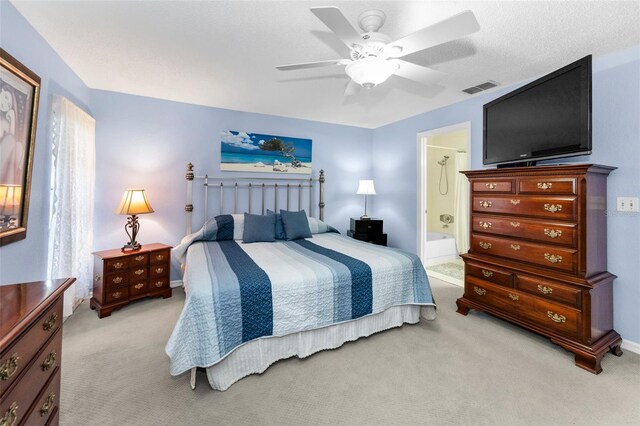 1948 Elaine Dr, Clearwater, FL 33760 - bedroom featuring light colored carpet, ceiling fan, ensuite bathroom, and baseboards