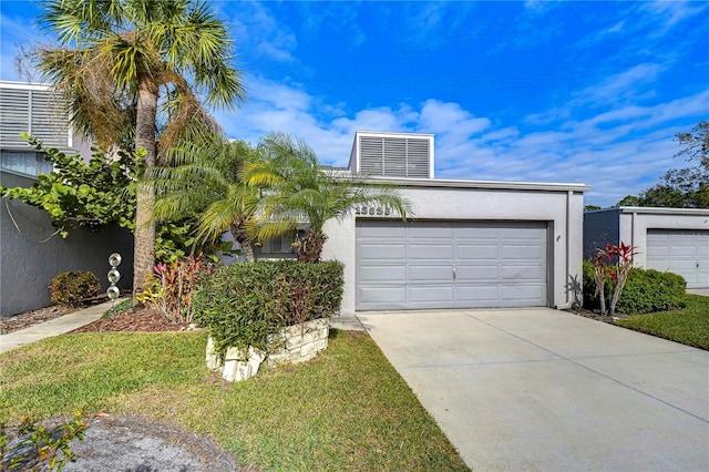 13635 Twin Lakes Ln Unit 13635, Tampa, FL 33618 - view of front of property featuring driveway, a garage, and stucco siding