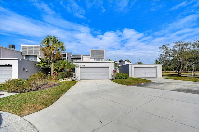 13635 Twin Lakes Ln Unit 13635, Tampa, FL 33618 - view of front of house featuring stucco siding and a garage