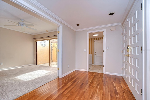 13635 Twin Lakes Ln Unit 13635, Tampa, FL 33618 - spare room featuring light wood-style floors, baseboards, a ceiling fan, and ornamental molding