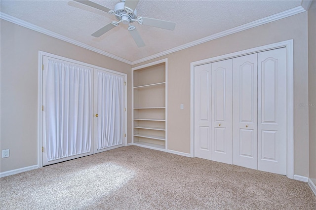 13635 Twin Lakes Ln Unit 13635, Tampa, FL 33618 - unfurnished bedroom featuring carpet flooring, a textured ceiling, crown molding, baseboards, and a ceiling fan