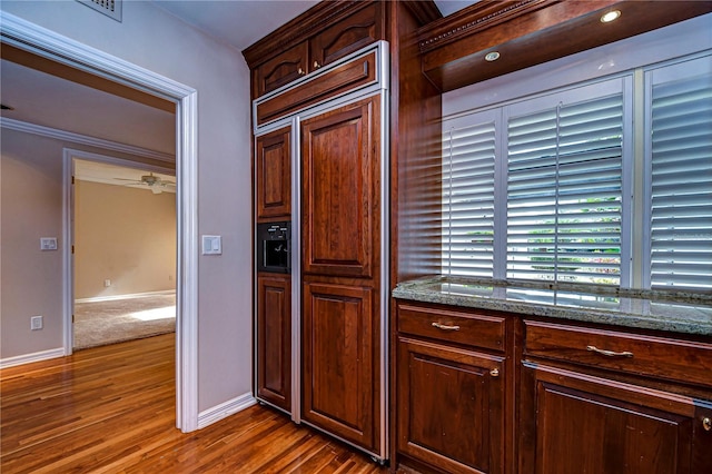 13635 Twin Lakes Ln Unit 13635, Tampa, FL 33618 - kitchen with paneled built in refrigerator, dark wood-style floors, dark stone countertops, baseboards, and a ceiling fan