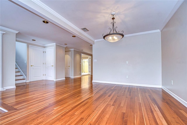13635 Twin Lakes Ln Unit 13635, Tampa, FL 33618 - unfurnished living room with wood-type flooring, stairway, baseboards, crown molding, and ornate columns