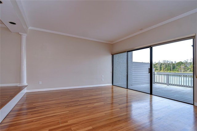 13635 Twin Lakes Ln Unit 13635, Tampa, FL 33618 - unfurnished bedroom with ornate columns, access to outside, light wood-style flooring, baseboards, and ornamental molding