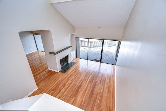 13635 Twin Lakes Ln Unit 13635, Tampa, FL 33618 - unfurnished living room featuring a fireplace, wood finished floors, and baseboards