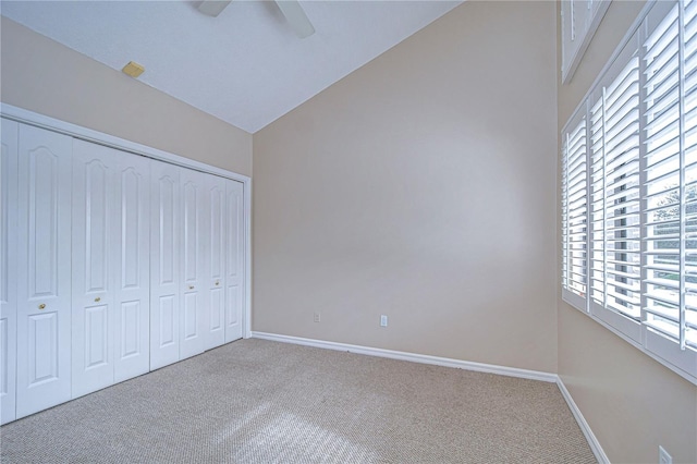 13635 Twin Lakes Ln Unit 13635, Tampa, FL 33618 - unfurnished bedroom with carpet floors, multiple windows, baseboards, a closet, and lofted ceiling