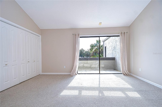 13635 Twin Lakes Ln Unit 13635, Tampa, FL 33618 - unfurnished bedroom featuring access to exterior, carpet flooring, baseboards, and lofted ceiling
