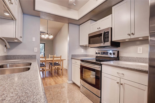 11800 Park Blvd Unit 208, Seminole, FL 33772 - kitchen with appliances with stainless steel finishes, white cabinets, light countertops, and light tile patterned floors