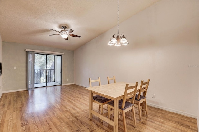 11800 Park Blvd Unit 208, Seminole, FL 33772 - dining space with light wood-style flooring, a ceiling fan, a chandelier, vaulted ceiling, and a textured ceiling