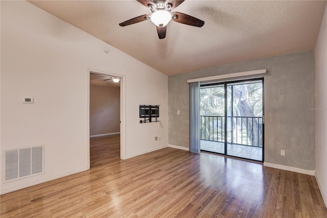 11800 Park Blvd Unit 208, Seminole, FL 33772 - empty room featuring a ceiling fan, wood finished floors, vaulted ceiling, and a textured ceiling