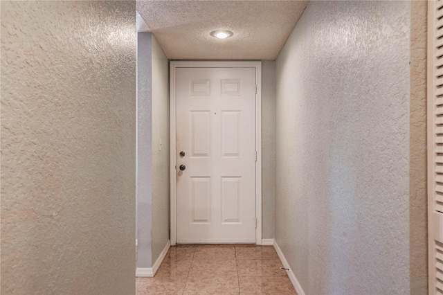11800 Park Blvd Unit 208, Seminole, FL 33772 - doorway to outside featuring a textured wall, a textured ceiling, and light tile patterned flooring