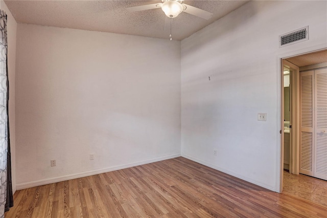 11800 Park Blvd Unit 208, Seminole, FL 33772 - unfurnished room featuring light wood-type flooring, ceiling fan, and a textured ceiling